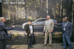 SF Motors CEO John Zhang, second from left, and Indiana Gov. Eric Holcomb, second from right, pose for picture in front of a mural of the SF 7, the company's electric vehicle, on Wednesday, May 30, 2018, in Mishawaka, Ind.