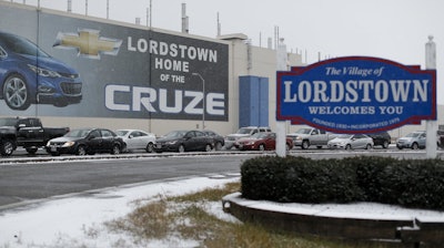 In this Nov. 27, 2018, file photo, a banner depicting the Chevrolet Cruze model vehicle displayed at the General Motors plant in Lordstown, Ohio.