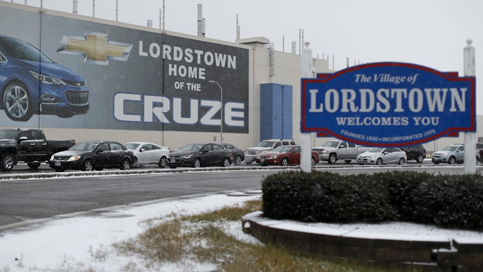 In this Nov. 27, 2018, file photo, a banner depicting the Chevrolet Cruze model vehicle displayed at the General Motors plant in Lordstown, Ohio.