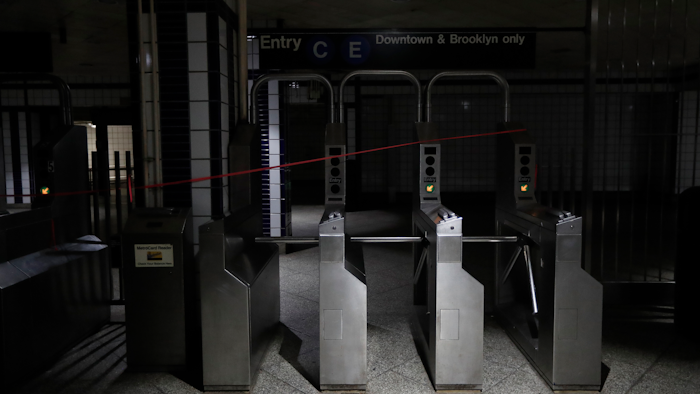 An entrance to the C and E trains at the 50th Street Subway Station is dimly lit during a power outage, Saturday, July 13, 2019, in New York. Authorities were scrambling to restore electricity to Manhattan following a power outage that knocked out Times Square's towering electronic screens and darkened marquees in the theater district and left businesses without electricity, elevators stuck and subway cars stalled.