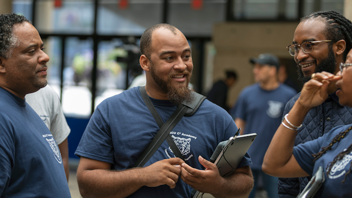 In this Friday, July 19, 2019, photo, Dennis Sigur (left), Nicholas Jackson (center) and Joshua Lewis participate in Tennessee State University’s coding and app development initiative in Nashville.
