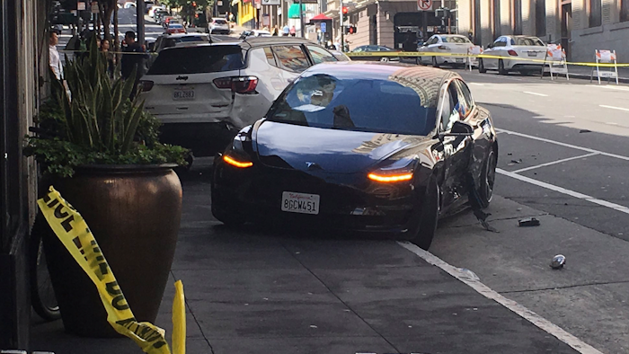 This photo taken Sunday, July 21, 2019, shows the scene after a woman was arrested after running a red light in a rented Tesla in San Francisco.