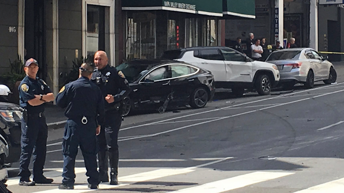This Sunday, July 21, 2019, file photo shows the scene after a woman was arrested after running a red light in a rented Tesla in San Francisco.