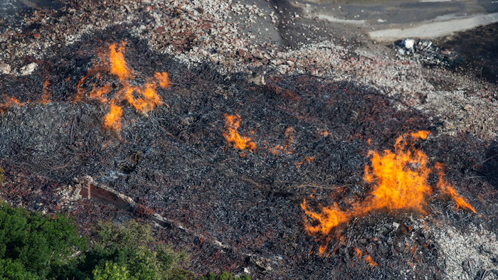 Flames and smoke rise from a bourbon warehouse fire at a Jim Beam distillery in Woodford County, Ky., Wednesday, July 3, 2019. Firefighters from four counties responded to the blaze that erupted late Tuesday.