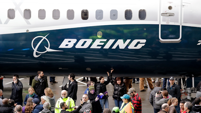 In this Feb. 5, 2018, file photo a Boeing 737 MAX 7, the newest version of Boeing's fastest-selling airplane, is displayed during a debut for employees and media of the new jet in Renton, Wash. Boeing says it's providing $100 million over several years to help families and communities affected by two crashes of its 737 Max plane that killed 346 people. The company said Wednesday, July 3, 2019, that some of the money will go toward living expenses and to cover hardship suffered by the families of dead passengers.