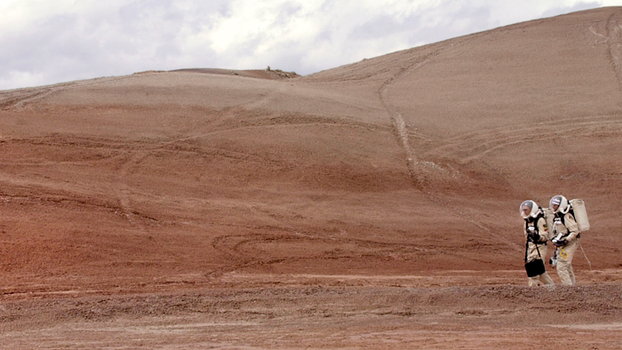 In this April 19, 2004, file photo, crew commander Gus Frederick and Greg Drayer, left, explore the terrain outside the Mars Desert Research Station northwest of Hanksville, Utah. Researchers at Brigham Young University are helping with a NASA-sponsored project measuring the electrical charge and size of dust particles on Mars.