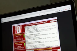 In this May 13, 2017, file photo, a screenshot of the warning screen from a purported ransomware attack, as captured by a computer user in Taiwan, is seen on laptop in Beijing.