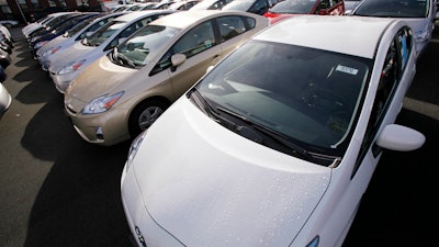 2010 model Toyota Prius cars fill a lot at a dealership in Seattle.
