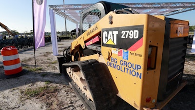 In this May 8, 2019 photo, a Caterpillar 279D Compact Track Loader sits at a demolition site in Fort Lauderdale, Fla.