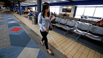 Chieko Asakawa uses an airport wayfinding app to navigate through Pittsburgh International Airside terminal, June 9, 2019.