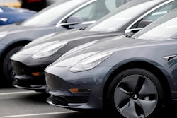 In this Sunday, May 19, 2019, file photo, a line of unsold 2019 Model 3 sedans sits at a Tesla dealership in Littleton, Colo.