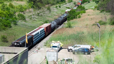 A freight train that derailed in an international tunnel connecting Michigan and Canada, sits on the track, Friday, June 28, 2019, in Port Huron, Mich.