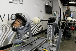 In this photo taken May 23, 2019, Ryan Smith, a test engineer at VICIS, a Seattle-based company that makes football helmets, runs an impact test on a helmet in Seattle. The company's latest offering is the ULTIM cap, which is intended for use with youth flag football and competitive 7-on-7 football played during the offseason for youth and high school programs.