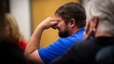A man reacts after a Blackjewel employee mentions not being able to deposit the cashiers check he received from the company during a public meeting at the Campbell County Courthouse in Gillette, Wyo., Tuesday afternoon, July 2, 2019.