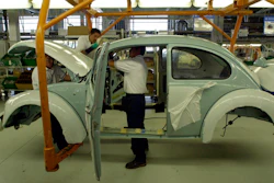 In this July 21, 2003, file photo, Volkswagen employees work in the assembly plant of the sedan 'last edition' in Puebla, Mexico.
