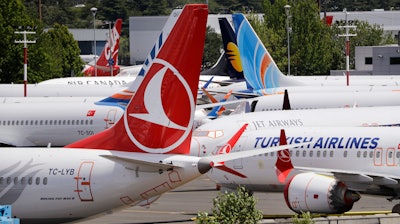 In this June 27, 2019, file photo, dozens of grounded Boeing 737 Max airplanes parked adjacent to Boeing Field in Seattle.