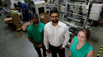 In this Friday, July 5, 2019, file photo, Achyut Patel, Rudy Patel and Katrina Hart at biodegradable bags maker beyond Green in Lake Forest, Calif.