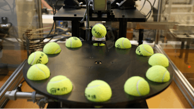 In this photo taken Friday June, 28, 2019, a tennis balls are lined up to squashed by pistons as they are tested by the International Tennis Federation (ITF) lab in Roehampton, near Wimbledon south west London. Based for about 20 years in a three-room area on what used to be a pair of squash courts in Roehampton, the ITF tech lab is filled with more than $1 million worth of machines that help make sure rules are followed and parameters are met.