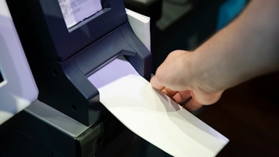In this June 13, 2019, photo, Steve Marcinkus, an Investigator with the Office of the City Commissioners, demonstrates the ExpressVote XL voting machine at the Reading Terminal Market in Philadelphia.