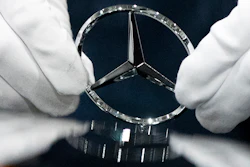 In this Wednesday, April 3, 2019, file photo, a worker wipes a logo of a car at the Mercedes Benz automobile assembly plant outside Moscow.