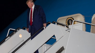 President Donald Trump steps off Air Force One as he arrives Friday, July 12, 2019, at Andrews Air Force Base, Md.
