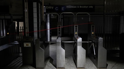 An entrance to the C and E trains at the 50th Street Subway Station is dimly lit during a power outage, Saturday, July 13, 2019, in New York. Authorities were scrambling to restore electricity to Manhattan following a power outage that knocked out Times Square's towering electronic screens and darkened marquees in the theater district and left businesses without electricity, elevators stuck and subway cars stalled.