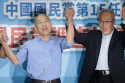 Kaohsiung city mayor Han Kuo-yu, left, celebrates with Wu Den-yih, chairman of the opposition National Party (KMT), after winning the candidacy of the opposition of the Nationalist Party (KMT), Monday, July 15, 2019, in Taipei.