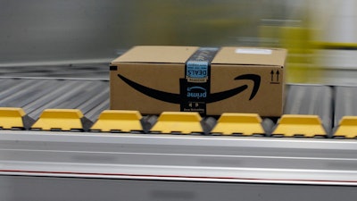 In this Feb. 9, 2018, file photo, a box for an Amazon prime customer moves through the new Amazon Fulfillment Center in Sacramento, Calif.