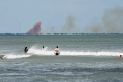 In this April 20, 2019, file photo, cloud of orange smoke rises over nearby Cape Canaveral Air Force Station, as seen from Cocoa Beach, Fla., after the SpaceX Dragon 2 capsule was destroyed during a test.