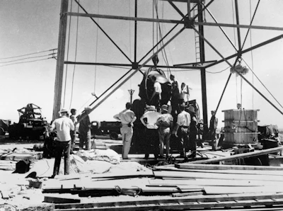 In this July 6, 1945, file photo, scientists and workmen rig the world's first atomic bomb to raise it up onto a 100 foot tower at the Trinity bomb test site near Alamagordo, N.M.