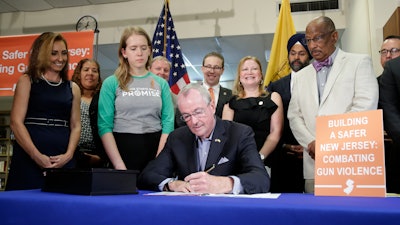 New Jersey Gov. Phil Murphy signs a gun control bill during a ceremony in Berkeley Heights, N.J., Tuesday, July 16, 2019.