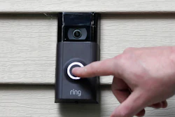 In this Tuesday, July 16, 2019, photo, Ernie Field pushes the doorbell on his Ring doorbell camera at his home in Wolcott, Conn.