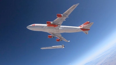 This Wednesday, July 10, 2019, photo shows a rocket being released from under the wing of a Boeing 747 during a test flight in Mojave, Calif.