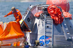 In this July 13, 2017, file photo, NASA astronaut Mike Fincke jumps into a life raft from an Orion capsule off Galveston Island, Texas.