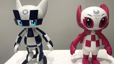 In this Thursday, July 18, 2019, photo, robots of mascots of Olympics 'Miraitowa,' left, and Paralympics 'Someity' are shown to the media at Toyota Motor Corp. headquarters in Tokyo.