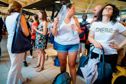 Passengers check train times at Naples' Central station, southern Italy, Monday, July 22, 2019.