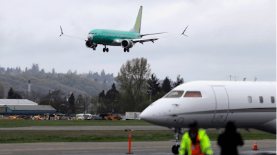 In this April 10, 2019, file photo, a Boeing 737 MAX 8 airplane lands following a test flight in Seattle.