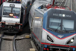 In this March 12, 2016, file photo, an Amtrak train passes a New Jersey Transit train in Elizabeth, N.J.