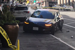 This photo taken Sunday, July 21, 2019, shows the scene after a woman was arrested after running a red light in a rented Tesla in San Francisco.
