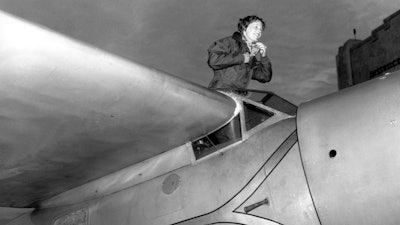 In this Jan. 13, 1935, file photo, American aviatrix Amelia Earhart climbs from the cockpit of her plane at Los Angeles, Calif.