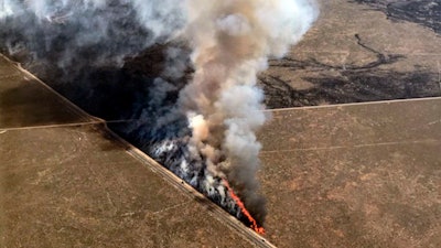 This photo provided by the U.S. Bureau of Land Management (BLM) shows wildfires burning in Idaho, Wednesday, July 24, 2019. The largest wildfire at the nation's primary nuclear research facility in recent history had been burning close to buildings containing nuclear fuel and other radioactive material, but a change in wind direction Wednesday was pushing the flames into open range at the sprawling site in Idaho, officials said. The lightning-caused fire at the Idaho National Laboratory is one of several across the U.S. West.