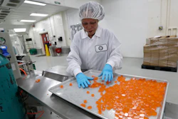 Ioka Tasi works on packaging cannabis-infused mango hard candies at Evergreen Herbal, Wednesday, July 24, 2019, in Seattle.