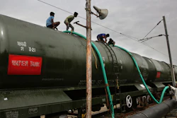 In this Wednesday, July 17, 2019, photo, workers fill wagons of a train with drinking water piped in from the Mettur dam at Jolarpet railway station, Tamil Nadu, India.