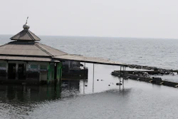 A man fishes near an abandoned mosque in Jakarta, Saturday, July 27, 2019.