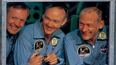 In this July 24, 1969, file photo, Apollo 11 astronauts, Neil Armstrong, left, Michael Collins, center, and Edwin 'Buzz' Aldrin smile as they answer questions from quarantine in an isolation unit aboard the USS Hornet after splashdown and recovery. The Honolulu Star-Advertiser reported Wednesday, July 24, 2019, the 50th anniversary of the astronaut's return to Earth, that the crew hit the atmosphere at 25,000 mph, creating a fireball that was visible to the crew of the waiting recovery aircraft carrier USS Hornet stationed about 900 miles (1,448 kilometers) southwest of Hawaii.