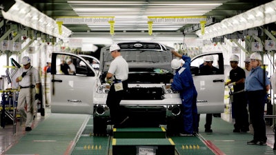 A Toyota Tundra truck is inspected during the final stages of assembly in San Antonio.