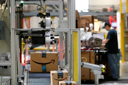 In this Aug. 3, 2017, file photo, packages pass through a scanner at an Amazon fulfillment center in Baltimore. Amazon will spend more than $700 million to provide additional training to about one-third of its U.S. workforce.