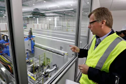 In this May 19, 2016, file photo, Eric Lindblad, vice president in charge of the Boeing 777X wing, looks over the 'clean' room area of the new 777X Composite Wing Center, a day ahead of its grand opening in Everett, Wash. Lindblad, the executive who manages the Boeing 737 Max program and the Seattle-area factory where the now-grounded plane is built, said he planned to retire last summer, and a Boeing spokesman said Thursday, July 11, 2019, that Lindblad's decision was unrelated to two deadly accidents involving Max jets.