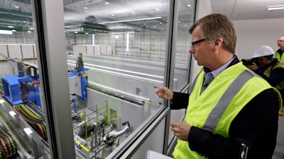 In this May 19, 2016, file photo, Eric Lindblad, vice president in charge of the Boeing 777X wing, looks over the 'clean' room area of the new 777X Composite Wing Center, a day ahead of its grand opening in Everett, Wash. Lindblad, the executive who manages the Boeing 737 Max program and the Seattle-area factory where the now-grounded plane is built, said he planned to retire last summer, and a Boeing spokesman said Thursday, July 11, 2019, that Lindblad's decision was unrelated to two deadly accidents involving Max jets.