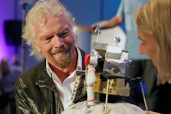 Richard Branson is presented with a space-themed cake during a luncheon attended by 100 Virgin Galactic ticket holders, to mark his 69th birthday and in recognition of the Apollo 11 moon landing anniversary at the Kennedy Space Center Visitor Complex, Thursday, July 18, 2019, in Cape Canaveral, Fla.